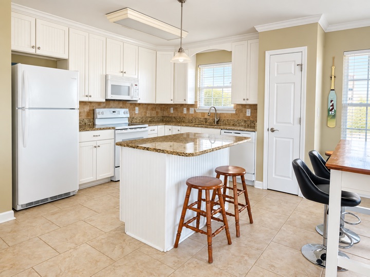 Kitchen with white cabinets and a center island