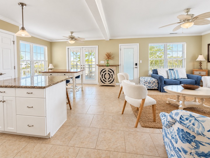 Open living and kitchen area with windows and French doors